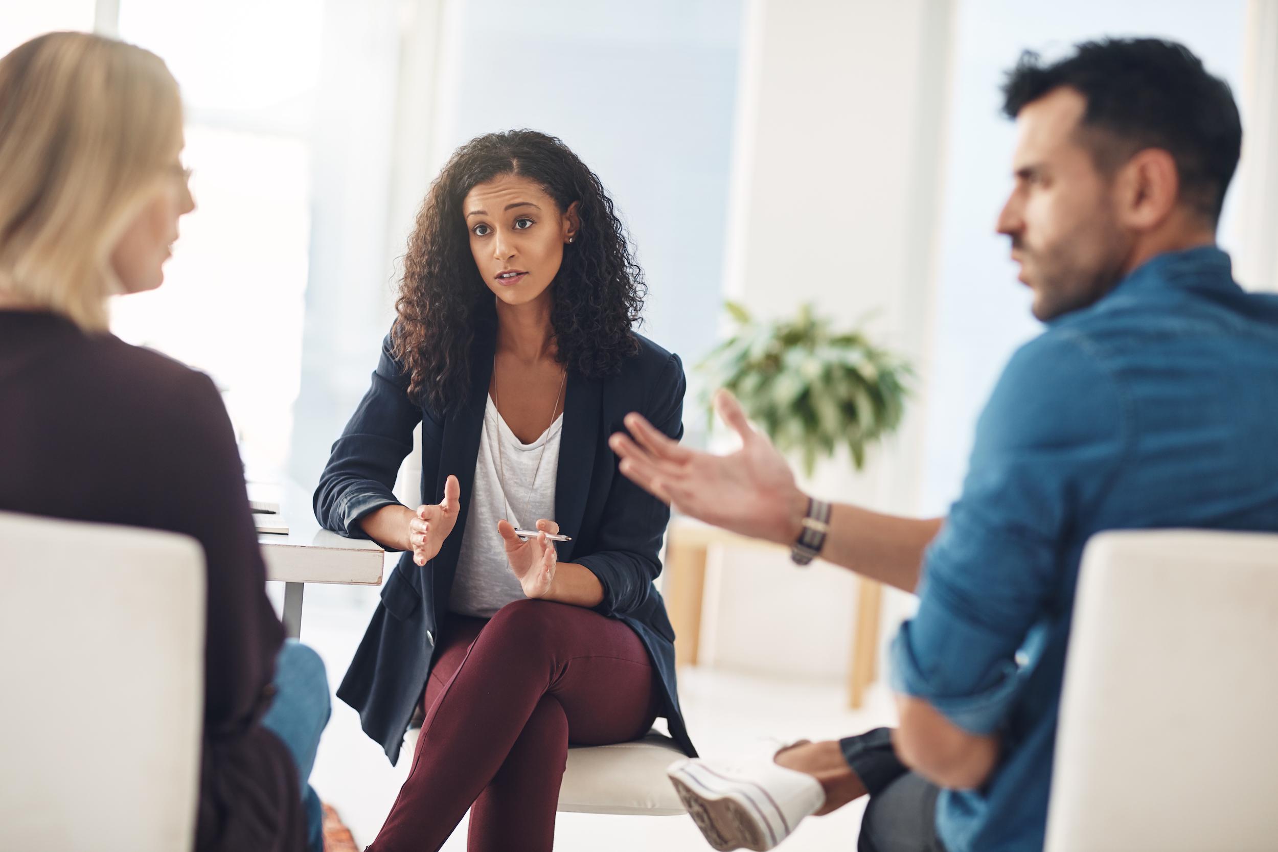 woman therapist talking with couple